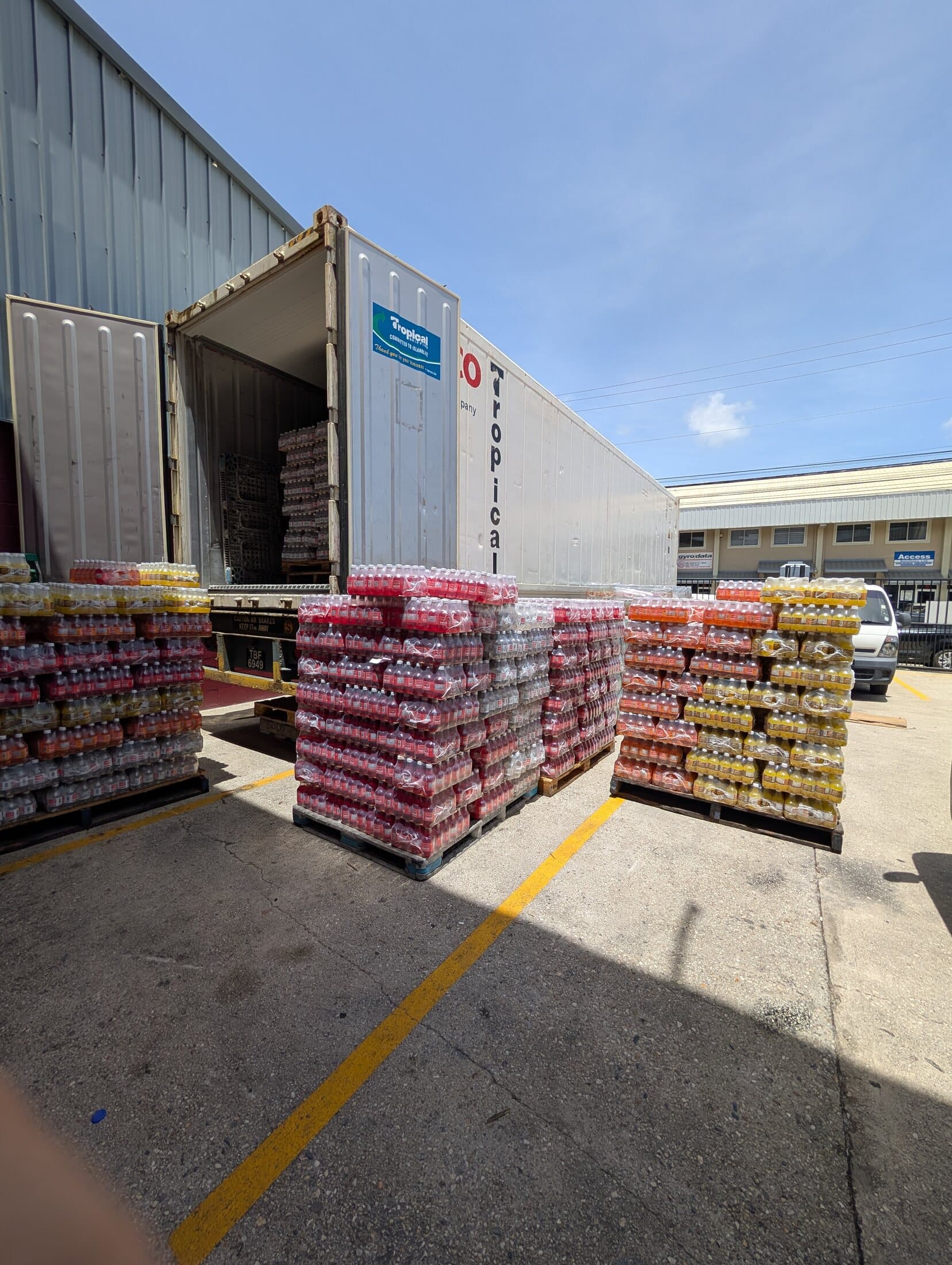 Prepared pallet loads staged beside an export container